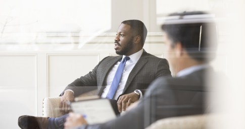 Man handing a paper to a colleague