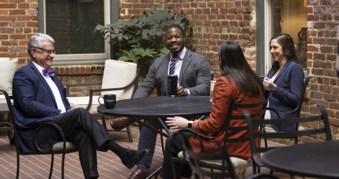 Man handing a paper to a colleague