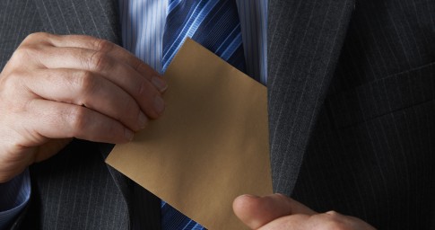 Man inserting envelop into jacket